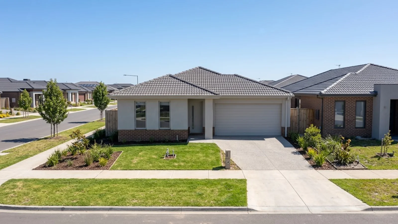 A freshly rendered single-storey brick veneer family home with a smooth acrylic finish in an outer south-eastern housing estate.