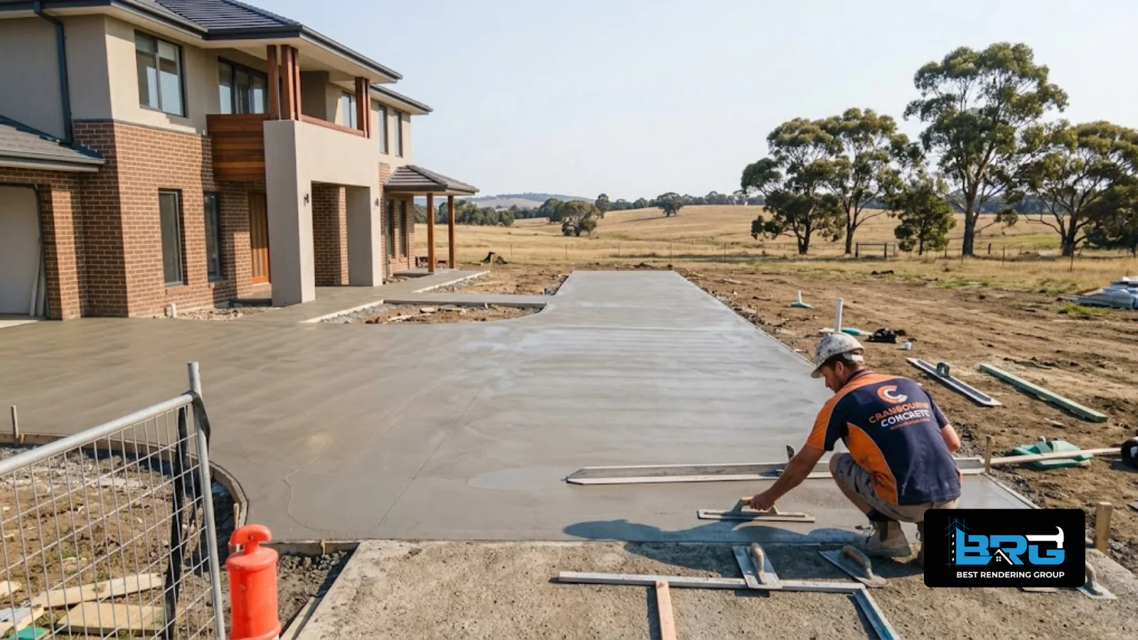 A tradesperson finishing a concrete surface outside a larger rural-residential style property near Cranbourne South, Melbourne, open paddock-style land visible in the background.